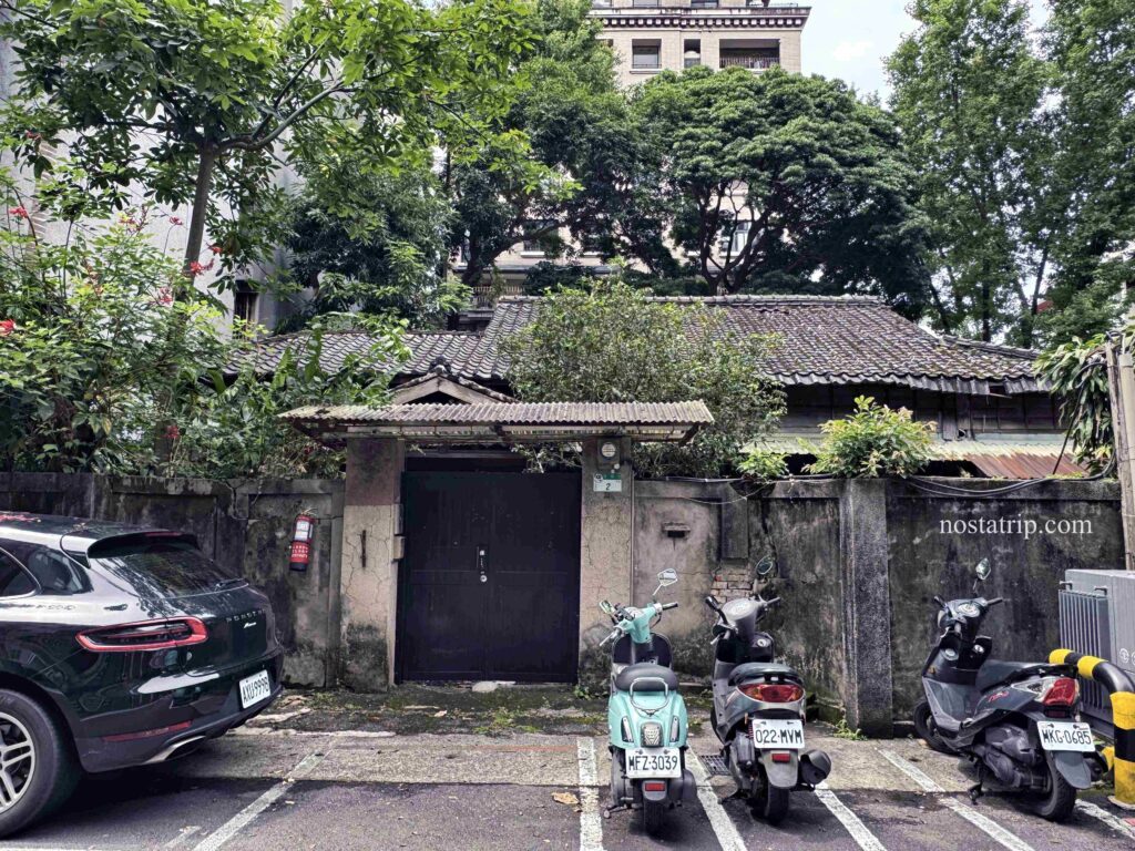 青田街七巷2號老屋木門外觀與圍牆前機車停車景象