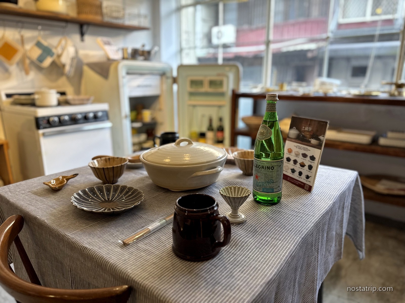 小器生活赤峰28店餐桌上的白色鍋具、咖啡杯與綠色玻璃瓶